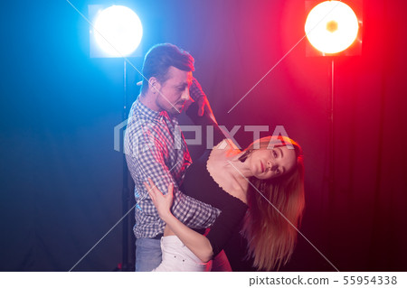 Social dance, bachata, salsa, kizomba, zouk and tango concept - Man hugs woman while dancing over Social dance, bachata, salsa, kizomba, zouk and tango concept - Man hugs woman while dancing over 55954338
