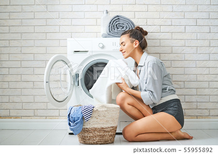 woman is doing laundry woman is doing laundry 55955892