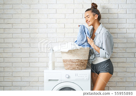 woman is doing laundry woman is doing laundry 55955893