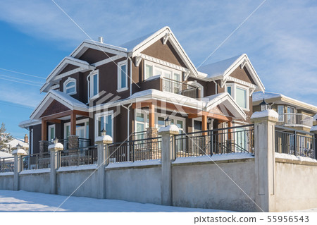 Luxurious residential house in snow on winter sunny day in Canada 55956543