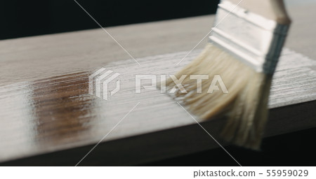 applying oil finish with brush to black walnut board applying oil finish with brush to black walnut board 55959029