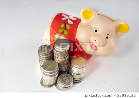 saving money with Red piggy bank and coins pile saving money with Red piggy bank and coins pile 55959188