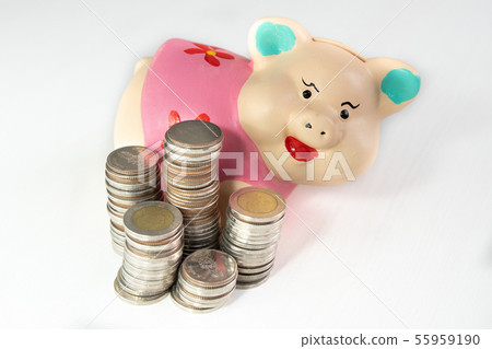 saving money with Pink piggy bank and coins pile saving money with Pink piggy bank and coins pile 55959190