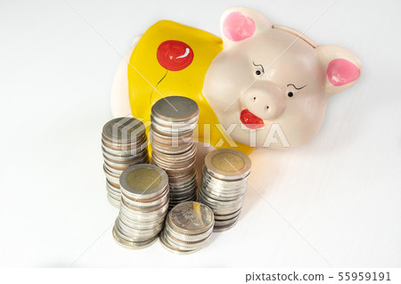 saving money with Yellow piggy bank and coins pile saving money with Yellow piggy bank and coins pile 55959191