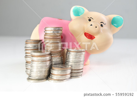 saving money with Pink piggy bank and coins pile 55959192