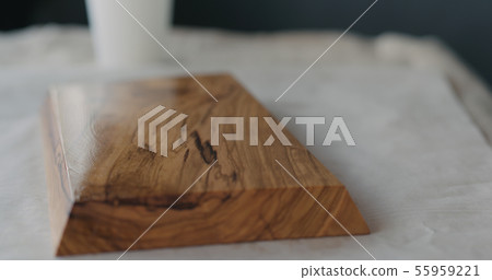 woodworker applying oil finish to olive wood board woodworker applying oil finish to olive wood board 55959221