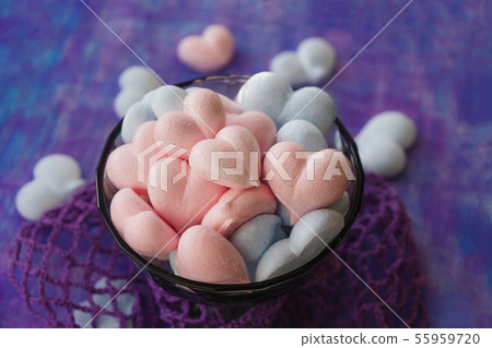 pink and blue meringue hearts on painted purple background with stripe and violet cotton mesh 55959720
