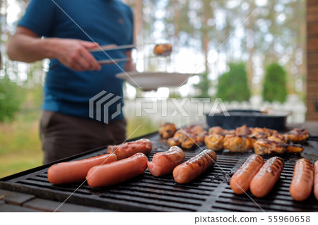 Delicious sausages and chicken legs are fried on bbq 55960658