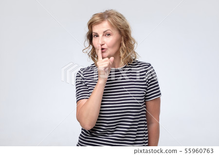 Serious lovely female asks to keep secret information confidential. 55960763