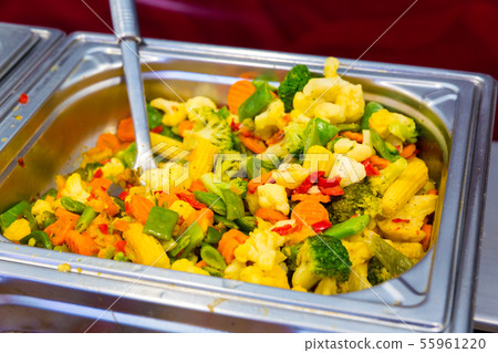 Steamed vegetables in metal tray, dining room Steamed vegetables in metal tray, dining room 55961220