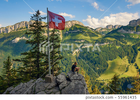 Tourist sitting on the Ebenalp mountain in the Swiss Alps of Switzerland 55961435