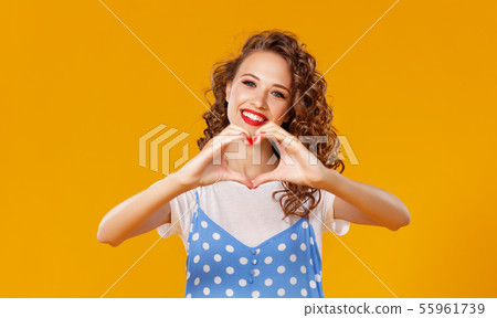 beautiful funny girl holds hands in shape of a 55961739