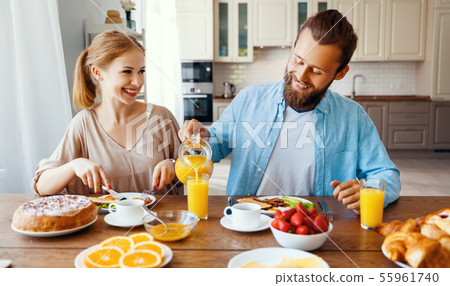 family happy couple have Breakfast in kitchen in 55961740
