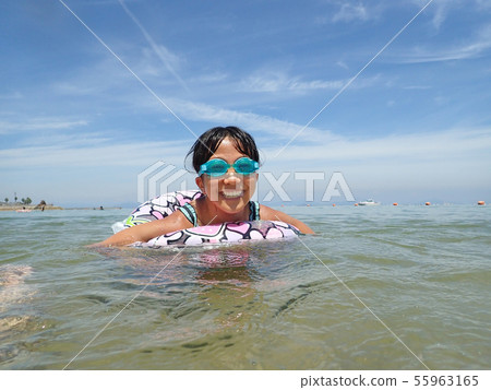 A girl who enjoys swimming A girl who enjoys swimming 55963165