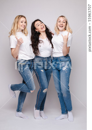 Three friends looking at camera and shouting in Three friends looking at camera and shouting in 55963707