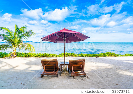 Beautiful landscape of beach sea ocean with empty chair deck and umbrella nearly coconut palm tree with white cloud and blue sky Beautiful landscape of beach sea ocean with empty chair deck and umbrella nearly coconut palm tree with white cloud and blue sky 55973711
