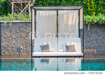 Outdoor swimming pool with umbrella chair lounge around there for leisure travel Outdoor swimming pool with umbrella chair lounge around there for leisure travel 55974288