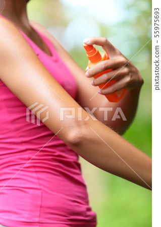 Mosquito repellent - woman using insect repellents Mosquito repellent - woman using insect repellents 55975693