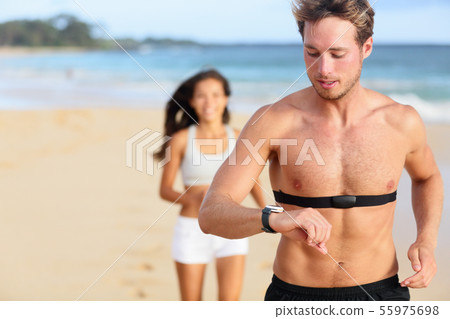 Running man jogging using heart rate monitor Running man jogging using heart rate monitor 55975698