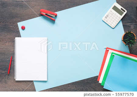Office desk with paper folders on blue Office desk with paper folders on blue 55977570