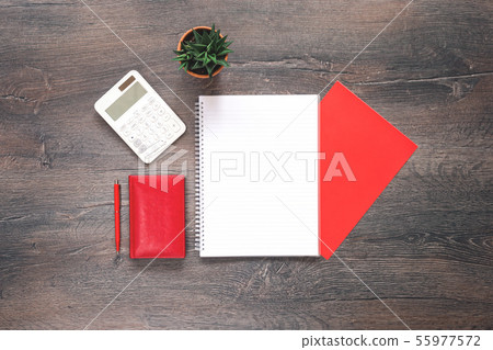 Red and white stationery on wooden desk Red and white stationery on wooden desk 55977572
