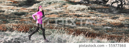 Running woman in winter trail mountain banner background. Runner athlete training cardio in cold Running woman in winter trail mountain banner background. Runner athlete training cardio in cold 55977868