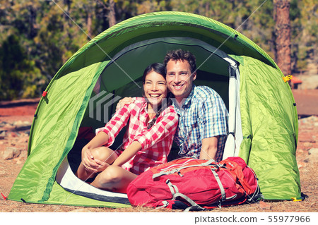 Happy Young Couple Relaxing In Tent Happy Young Couple Relaxing In Tent 55977966