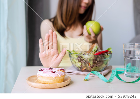 Young healthy woman using hand push out dessert 55979242