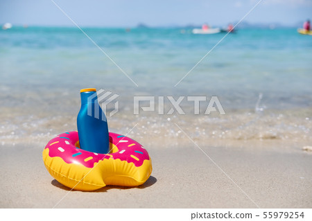 Sunscreen on white sandy tropical beach, Summer Sunscreen on white sandy tropical beach, Summer 55979254