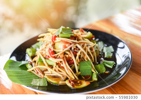 Papaya salad served on dining table - Green papaya 55981030
