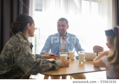 Military woman feeling happy looking at husband and daughter 55981830