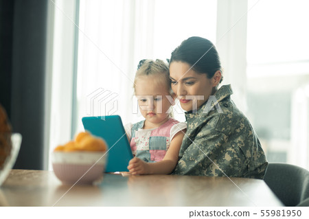 Woman after military service feeling happy hugging her child Woman after military service feeling happy hugging her child 55981950