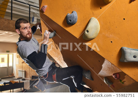 Powerful physically challenged man training hard at climbing classes 55982751