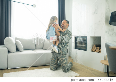 Girl running to her father seeing him in the living room 55982816