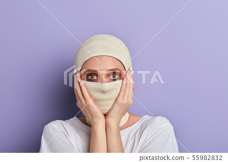 scared girl touching her cheek after plastic surgery scared girl touching her cheek after plastic surgery 55982832