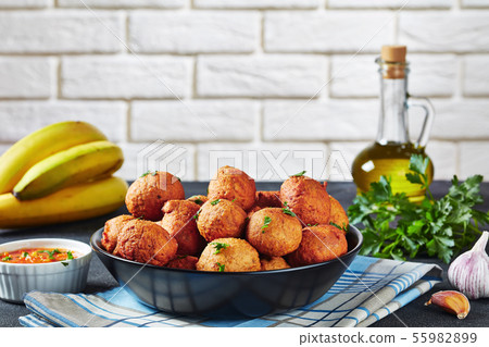 spicy Plantain fritters Klako in a black bowl 55982899