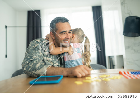 Military officer feeling emotional while hugging his cute lovely girl Military officer feeling emotional while hugging his cute lovely girl 55982989