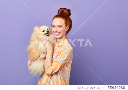 overjoyed girl takes care of her pet 55984088