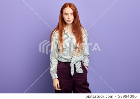 confident beautiful cheerful ginger girl posing to the camera confident beautiful cheerful ginger girl posing to the camera 55984090
