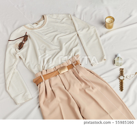 messy bed with clothes and accessories, top view photo. 55985160