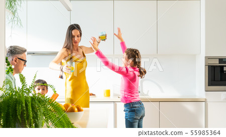 The young family with two children are drinking The young family with two children are drinking 55985364