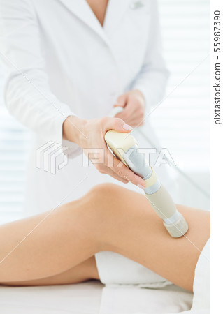 Female client of beauty clinic getting LPG massage on legs for lifting body 55987390