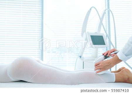 Female client of beauty clinic getting LPG massage on legs for lifting body 55987410