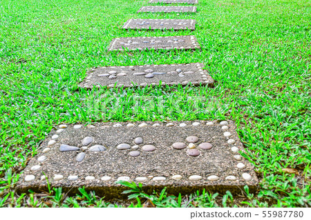 Beautiful brick blocks with flowers on the grass. Beautiful brick blocks with flowers on the grass. 55987780