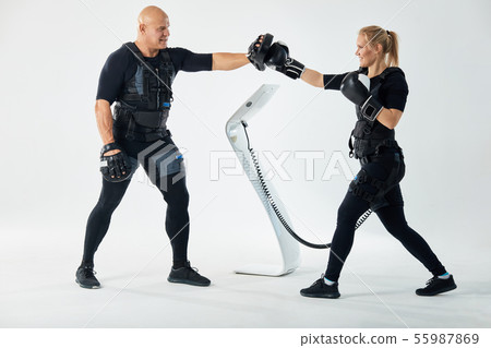 motivated girl and strong man practicing kicks motivated girl and strong man practicing kicks 55987869