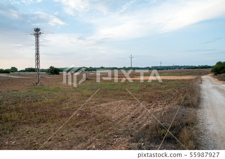 A steel tower built in large dry land in the countryside of Mallorca A steel tower built in large dry land in the countryside of Mallorca 55987927