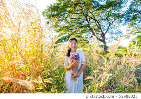 Fashion women in white dress with dry flower Fashion women in white dress with dry flower 55988023