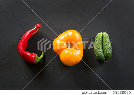 Ugly organic colorful tomato, pepper, cucumber on black. Ugly organic colorful tomato, pepper, cucumber on black. 55988030