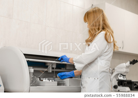 Laboratory technician test blood in automatic Laboratory technician test blood in automatic 55988834