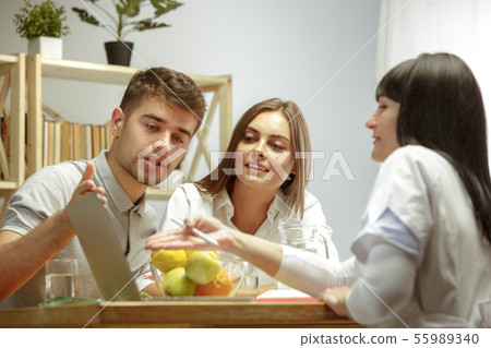 Smiling nutritionist showing a healthy diet plan to patient Smiling nutritionist showing a healthy diet plan to patient 55989340